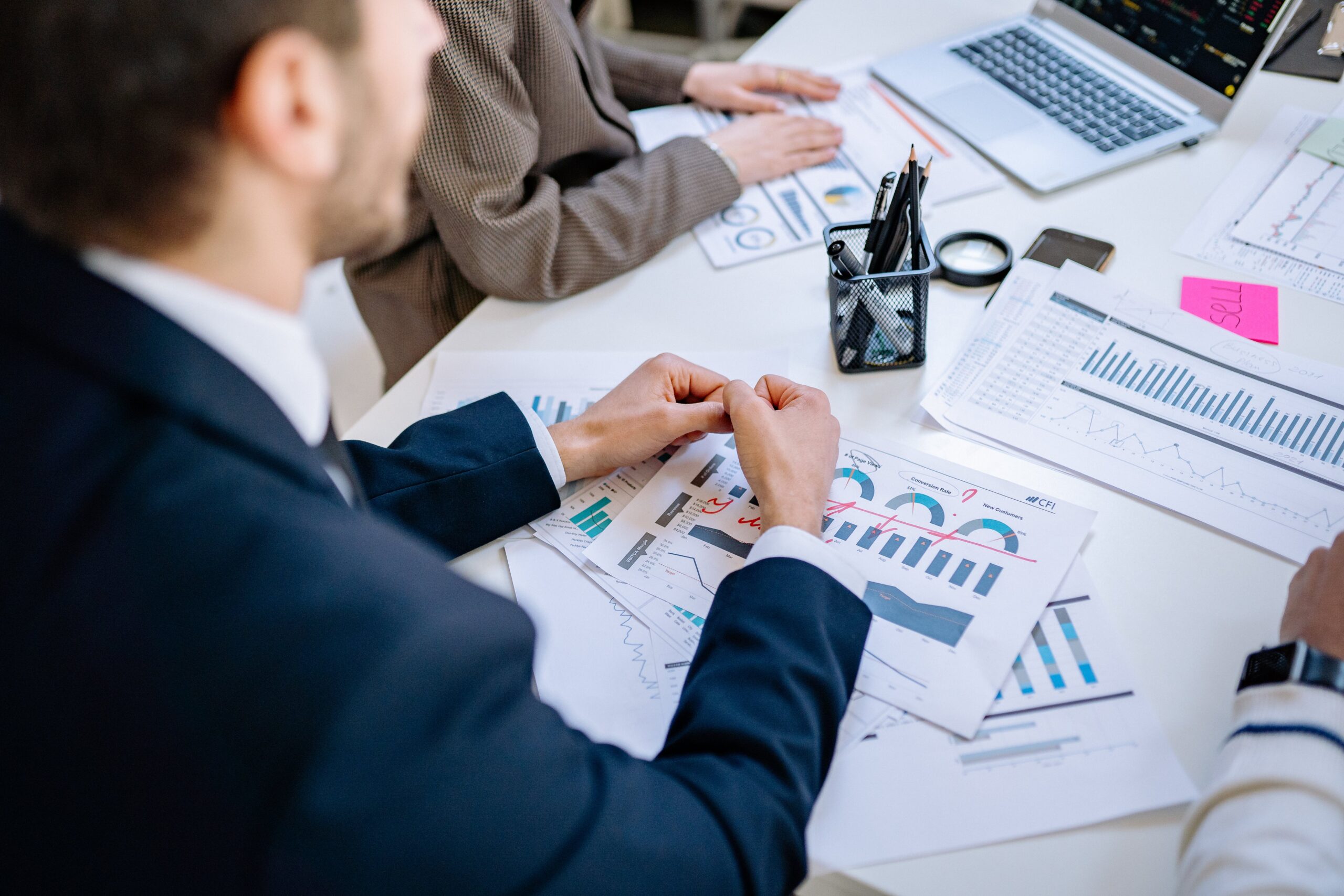 Lender employees analyze a business's financials, considering whether to offer them a loan.