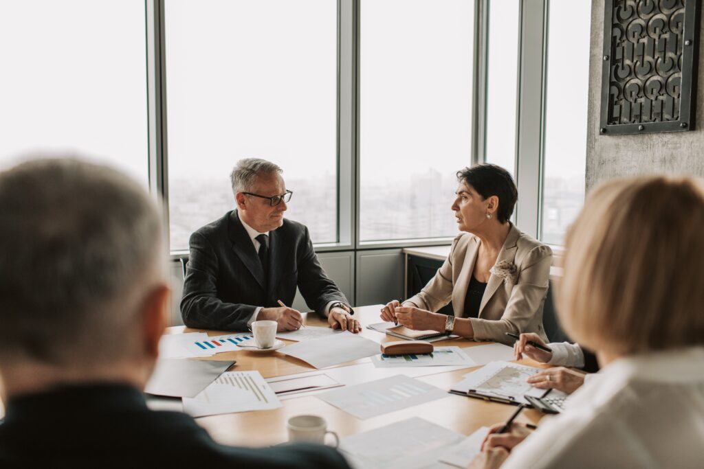 Two employees of a lender discuss a loan they're considering.